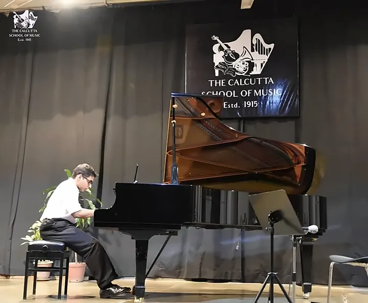 A student at the grand piano during a concert at The Calcutta School of Music