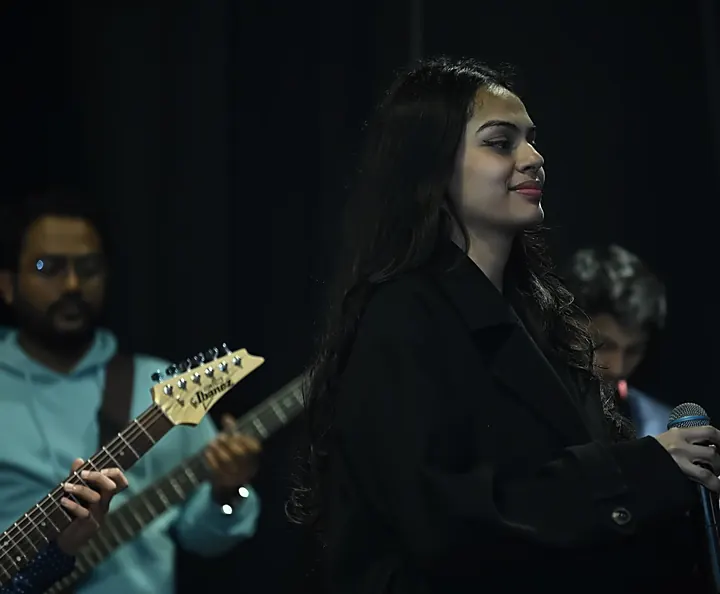 A singer with a guitarist at Confluence 2025