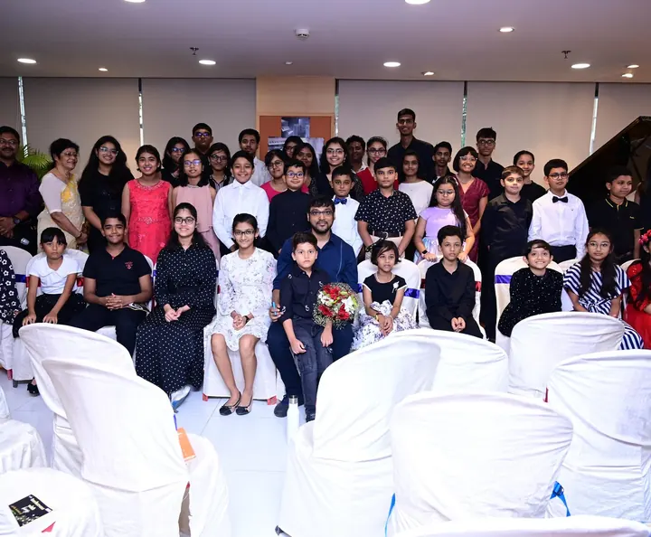 Students and families together after a recital at Theme Piano World