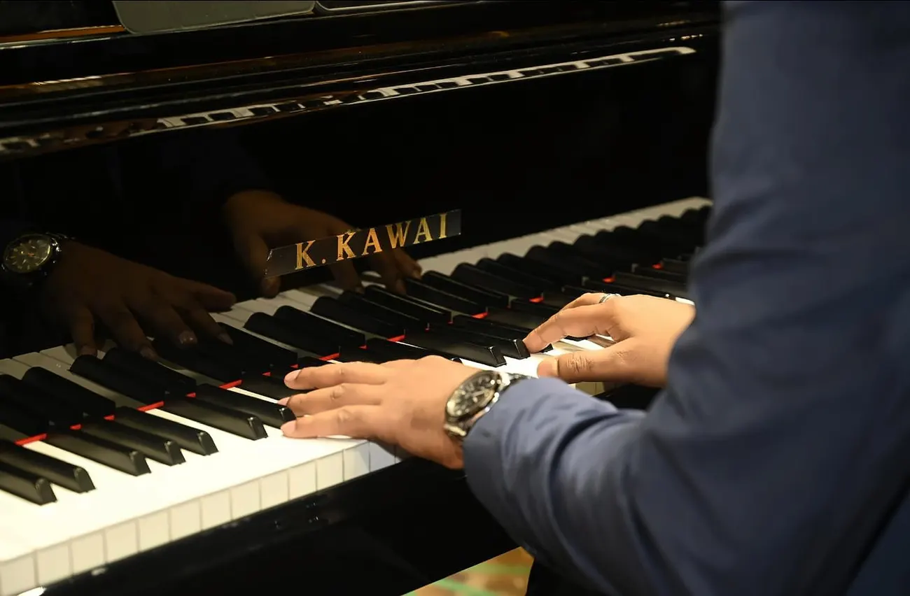 Kaushik Das playing the keys of a Kawai grand